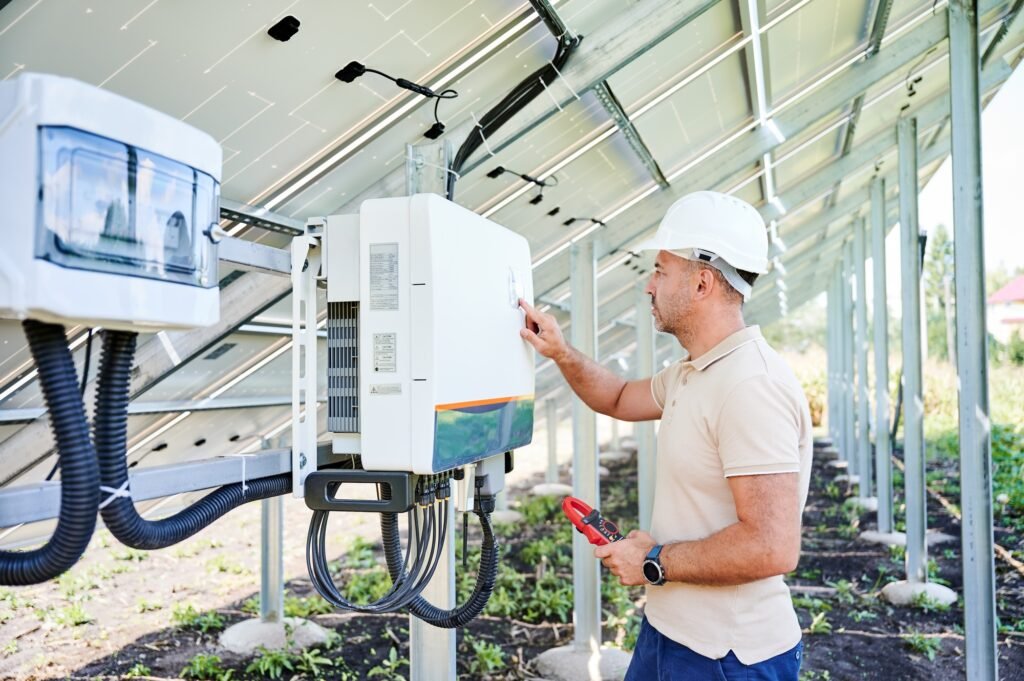 What is a Solar Inverter 2 Professional worker checking voltage on solar inverter.